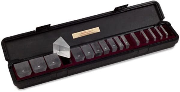 A set of 1 2 optical glass prisms in a case.